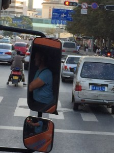 Kunming local on motorbike guiding us to the Hong He Hotel