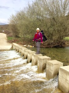 Kelly crossing Rio Erro stepping stones